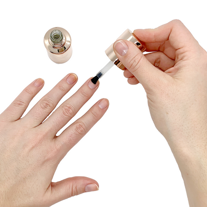 Person applying Nail Primer to natural nails with brush for longer-lasting manicure on white background