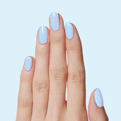 Hand with nails coated in Honest & True serene blue gel polish for a calm and refreshing at-home manicure