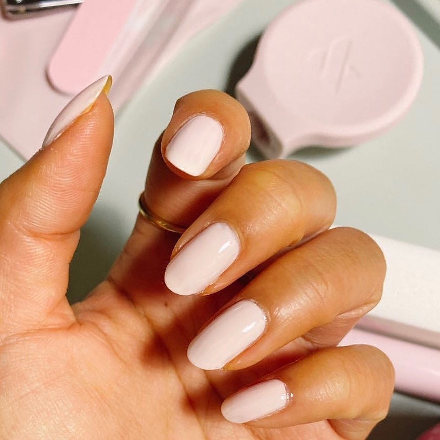 Hand displaying nails painted with GH, an opaque baby pink polish perfect for a radiant at-home manicure