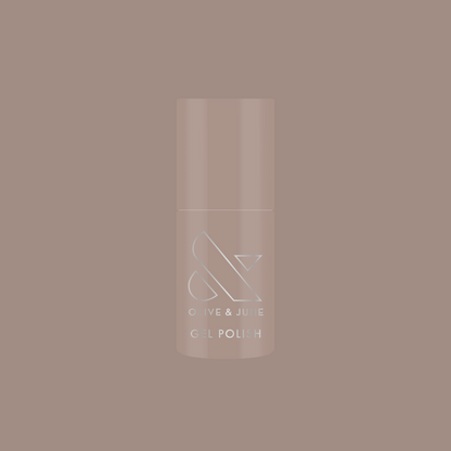 Bottle of AW - Gel polish in warm grey shade for chic, long-lasting manicure by Olive and June on muted background