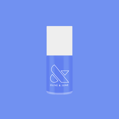 Bottle of Rally Ready nail polish in dusty ultramarine blue by Olive and June for long-lasting at-home mani and pedi