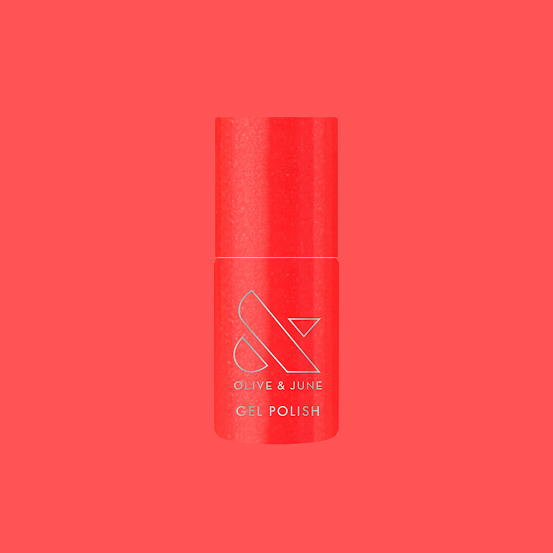 Bottle of Rodeo Queen - Gel nail polish in bright pinky-red with silver shimmer by Olive and June on red background