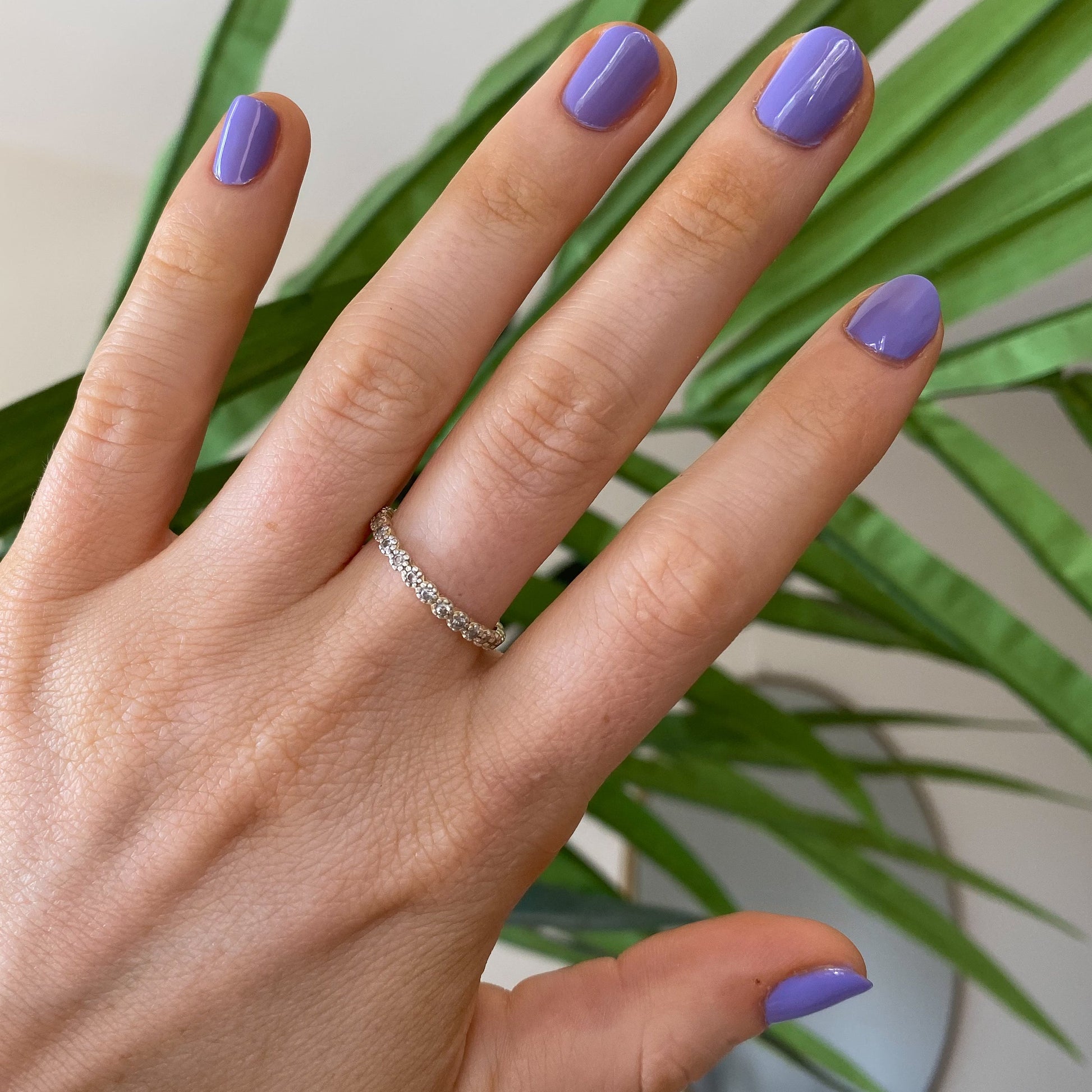 Hand with nails painted in Bold & Unshaken purple gel polish showing a vibrant, long-lasting manicure by Olive and June