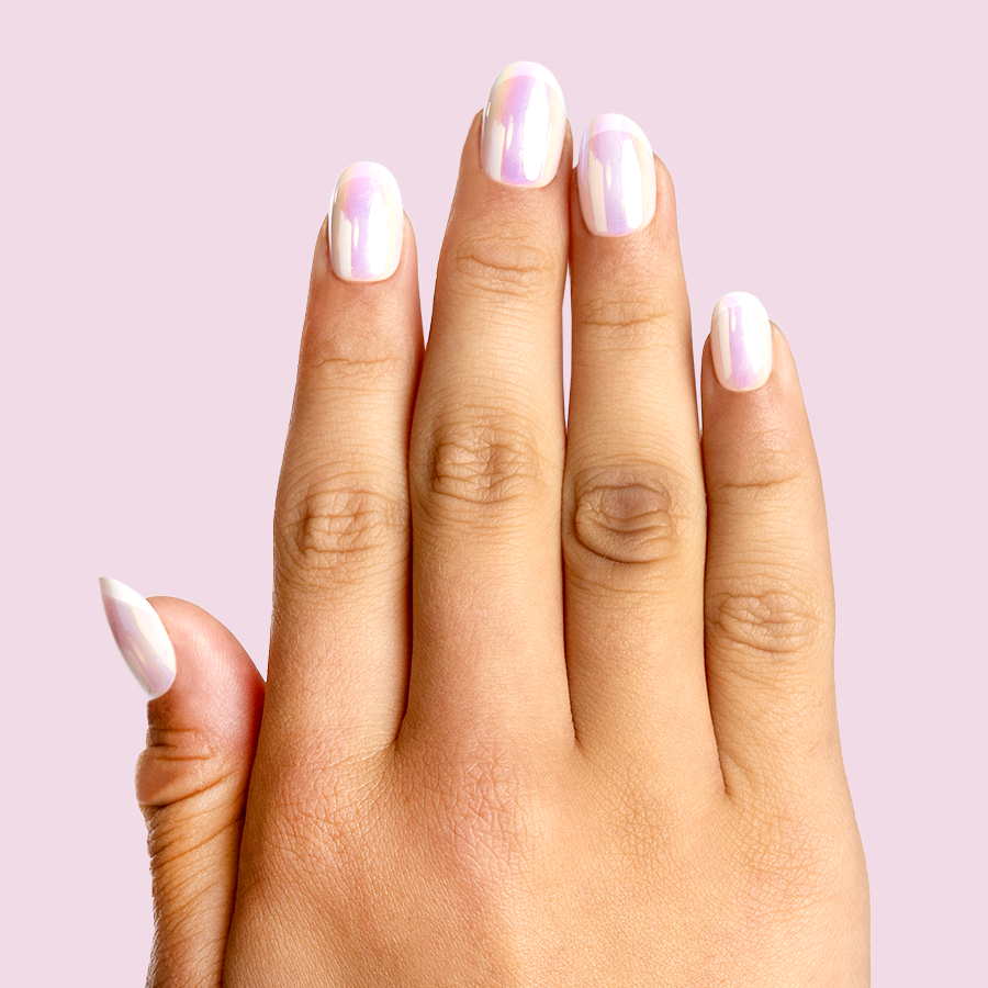 Cool in Chrome French - Pressies | Short Medium | Round showing iridescent chrome shimmer press-on manicure on hand against pale pink background