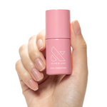 Nail Hardener bottle held by hand with natural nails for strengthening and protection in at-home manicures