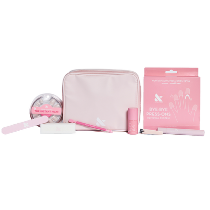 Press-On System - 4 Sets displayed with pink pouch, nail file, remover kit, brush, and nail polish for easy at-home mani care