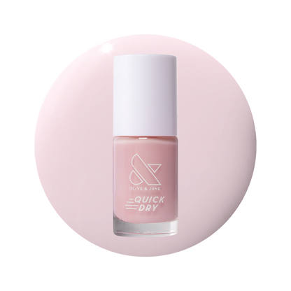 Puffball quick dry gel polish bottle in soft milky pink shade on pale pink circular background