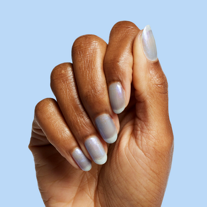 Hand with nails painted in cool lavender-blue iridescent manicure using Friend or Anemone? gel polish on blue background